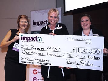 Beverley McClure from Impact San Antonio presents 2017 Impact San Antonio $100,000 Grant Award check to Denise Bennett and Stephanie Kotick